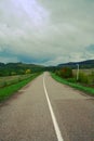 An open paved road leads into the distance.A dirt road in a forest thicket.the concept of Royalty Free Stock Photo