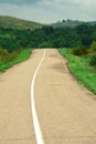 An open paved road leads into the distance.A dirt road in a forest thicket.the concept of Royalty Free Stock Photo