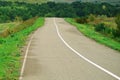 An open paved road leads into the distance.A dirt road in a forest thicket.the concept of Royalty Free Stock Photo