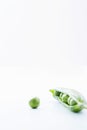 Open pea pod containing peas and single pea close-up Royalty Free Stock Photo