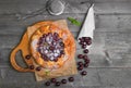 Open pie tart dough with ripe cherries