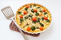 Open pie with vegetables and cheese in baking dish