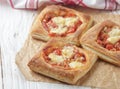 Open pies puff pastry with tomato, mozzarella, onion