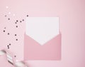 Open pink envelope, with a blank sheet of white paper, space for text