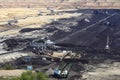 Open pit coal mine with machinery and excavators Royalty Free Stock Photo