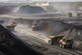 open-pit coal mine with massive mining trucks and equipment in the foreground Royalty Free Stock Photo