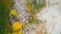 Open pit gravel mining sight with gravel field, big stones and beautiful autumn nature photographed from above with a drone. Royalty Free Stock Photo