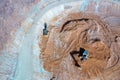 Open pit mine in full operation, with machinery extracting minerals