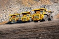 Open pit mine industry. Big yellow mining truck for coal moving on road career Royalty Free Stock Photo