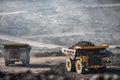 Open pit mine industry. Big yellow mining truck for coal moving on road career Royalty Free Stock Photo