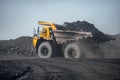 Open pit mine industry. Big yellow mining truck for coal moving on road career Royalty Free Stock Photo