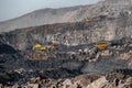 Open pit mine industry. Big yellow mining truck and excavator for coal moving on road career Royalty Free Stock Photo