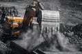 Open pit mine industry. Excavator work loading of coal into Yellow mining truck Royalty Free Stock Photo