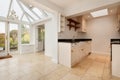 Open plan cottage kitchen opening to conservatory room Royalty Free Stock Photo