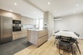 Open plan kitchen with oak cabinets, island with white marble top Royalty Free Stock Photo