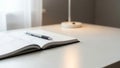Open Planner with Pen on White Desk, Minimalist Workspace Royalty Free Stock Photo
