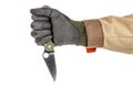 Open pocket folding knife with dark green handle clenched in a male fist in black protective glove isolated on white background