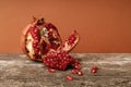 Open pomegranate, grains fell on the old board. pomegranate board and grain texture