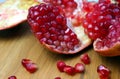 Open pomegranate with peel on a wooden table