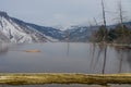 Open pool overlooking mountains at Mammoth Hot Springs terraces in the wintertime at Yellowstone National Park - beautiful steamin