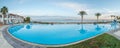 Open pool on the shores of the exotic ocean and the reflection of palm trees in the water. summer landscape. panoramic picture Royalty Free Stock Photo