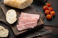 Open pork luncheon meat can with baguette, on old dark  wooden table background Royalty Free Stock Photo