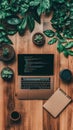 Open Portable Computer Displaying Code on Wooden Surface with Green Plants, Notebook and Cup for Cybersecurity Awareness Royalty Free Stock Photo