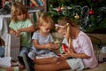 Open Presents On Christmas Morning.Children opening Xmas presents Royalty Free Stock Photo