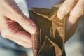 Open purse with coins inside as a sign of lack of money