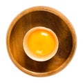 Open raw chicken egg in wooden bowl over white Royalty Free Stock Photo