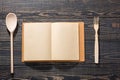 Open recipe book, on dark wooden background, view from the top Royalty Free Stock Photo
