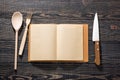 Open recipe book, on dark wooden background, view from the top Royalty Free Stock Photo