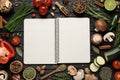 Open recipe book and ingredients on black wooden table, flat lay. Space for text Royalty Free Stock Photo