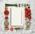 Open recipe book and different ingredients on white marble table, flat lay. Space for text Royalty Free Stock Photo