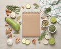 Open recipe book and different ingredients on white wooden table, flat lay. Space for text Royalty Free Stock Photo