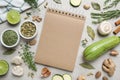 Open recipe book and different ingredients on white wooden table, flat lay. Space for text Royalty Free Stock Photo
