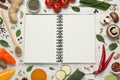 Open recipe book and different ingredients on white wooden table, flat lay. Space for text Royalty Free Stock Photo