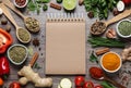 Open recipe book and different ingredients on table, flat lay. Space for text Royalty Free Stock Photo
