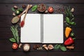 Open recipe book and ingredients on wooden table, flat lay. Space for text Royalty Free Stock Photo