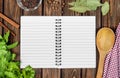 Open recipe book with fresh herbs and spices Royalty Free Stock Photo