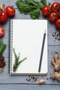 Open recipe book and fresh products on grey wooden table, flat lay. Space for text Royalty Free Stock Photo