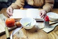 Open recipe book in the hands of an elderly woman