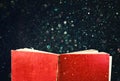 Open red book and glowing glittering lights. Royalty Free Stock Photo