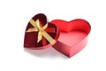 Open red heart shape gift box with golden ribbon Royalty Free Stock Photo