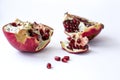 Open red juicy pomegranate fruit on white background. Necessary vitamins during seasonal spring hypovitaminosis