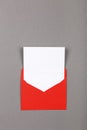 Open red paper envelope over grey