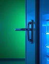 Open Refrigerator with Blue Light Against Green Wall Royalty Free Stock Photo