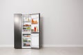 Open refrigerator filled with food, space for text