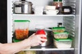 Open refrigerator with food in kitchen. Stocks of food for next mealtime