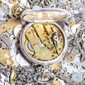 Open retro pocket watch on heap of spare parts Royalty Free Stock Photo